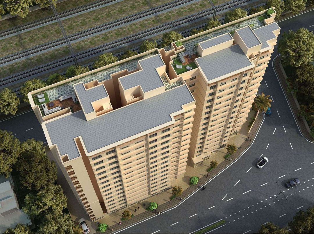 Aerial view of both wings from the rail side, showing the roof terraces and the road along the plot.