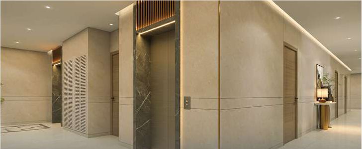 Lift lobby on a residential floor, with stone-clad walls and a patterned floor inlay.