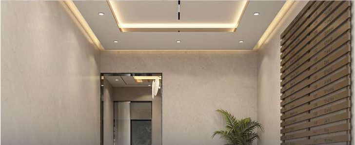 Reception foyer with a planter beside the lift door and a letterbox wall.