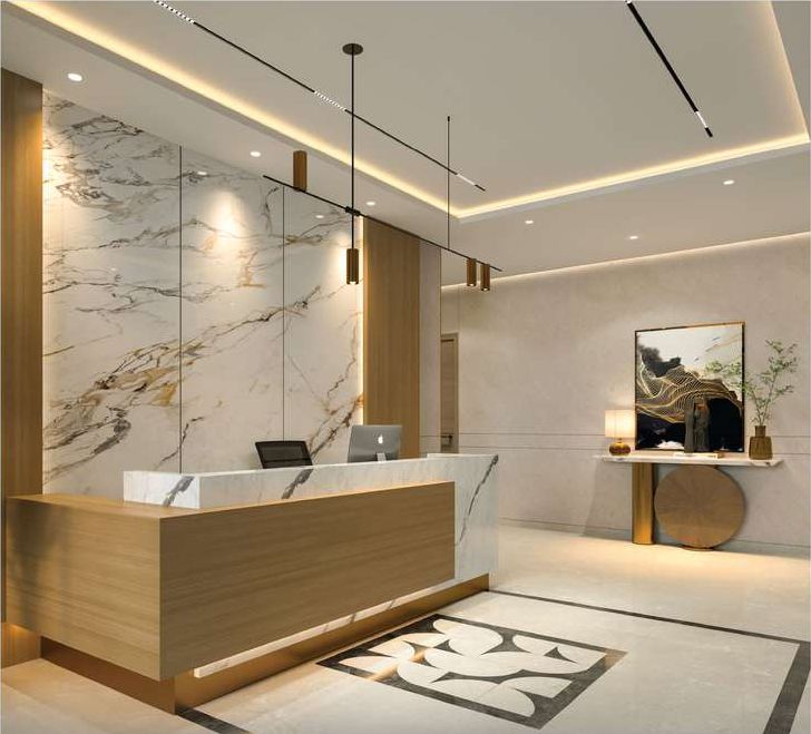 Entrance lobby with a reception desk, stone wall panelling and pendant lights.