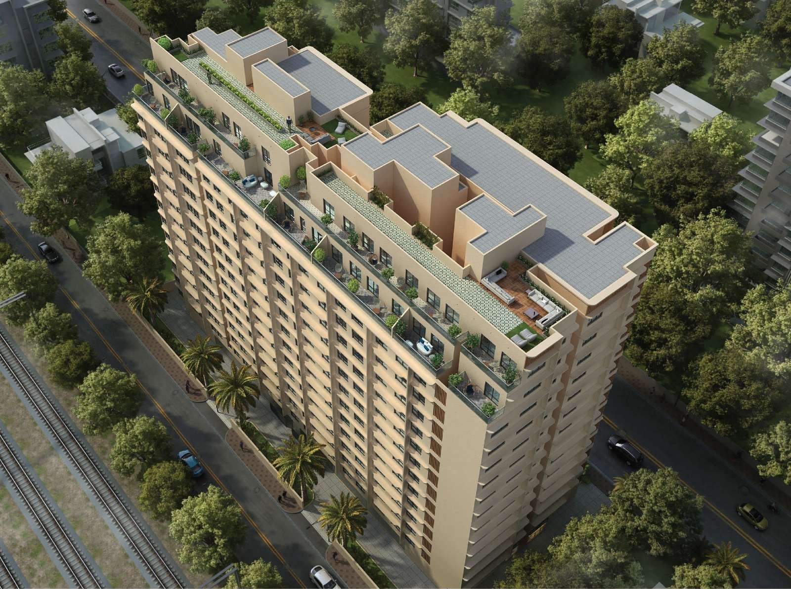 Aerial view of the two wings of Sankirt Jasmine, with planted rooftop terraces above and the suburban rail line running along the left edge of the plot.