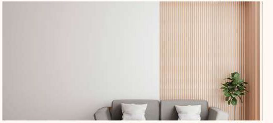 Living room wall in a plain pale finish next to a fluted timber panel.